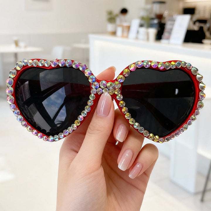 Sparkling rhinestone heart sunglasses for women, glamorous UV protection eyewear for a summer look.