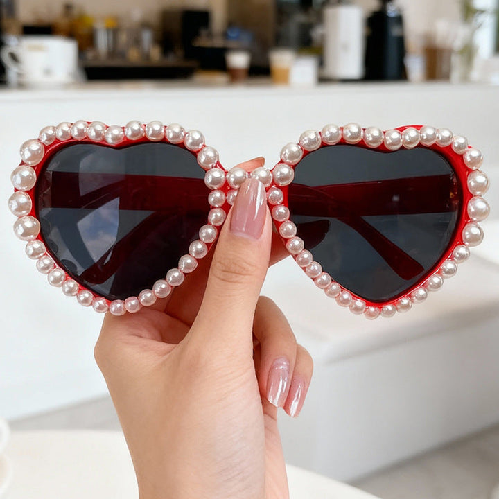 Women's heart-shaped rhinestone sunglasses, a chic fashion accessory with essential UV protection.
