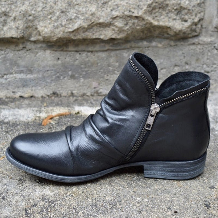 Chic women's leather ankle boots with side-zip for effortless style & comfort. Versatile low-heel fashion.