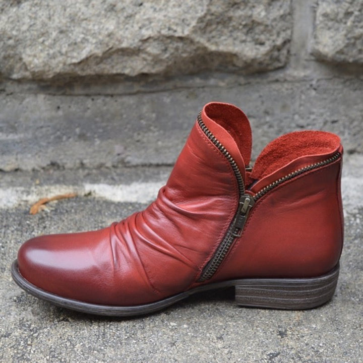 Elegant women's leather ankle boots with practical side-zip. Versatile low-heel design, perfect for everyday chic style.