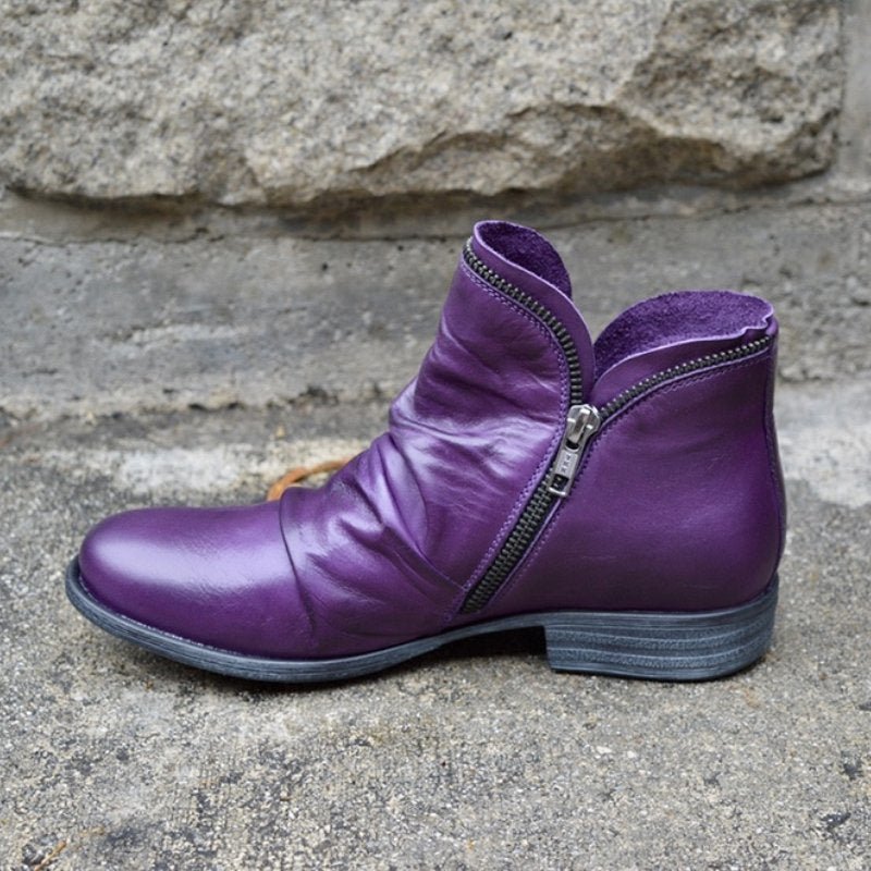 Fashionable women's leather side-zip ankle boots with low heel. Comfortable and chic for versatile everyday outfits.
