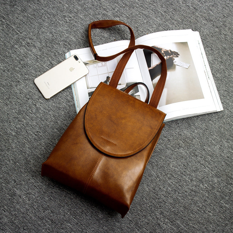Front view of a women's stylish leather backpack with sleek design & functional pockets.