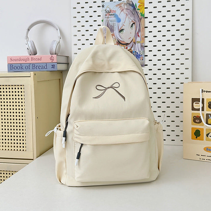 Elegant women's minimalist school bag featuring a dainty bow, perfect for students & fashion-conscious women.
