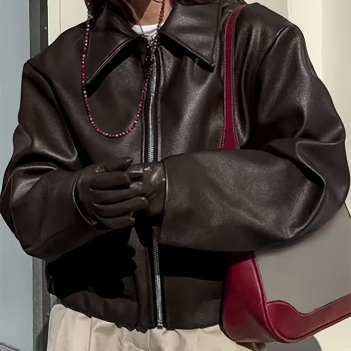Stylish women's outerwear, this chic moto jacket boasts a flattering lapel collar for a trendy look.
