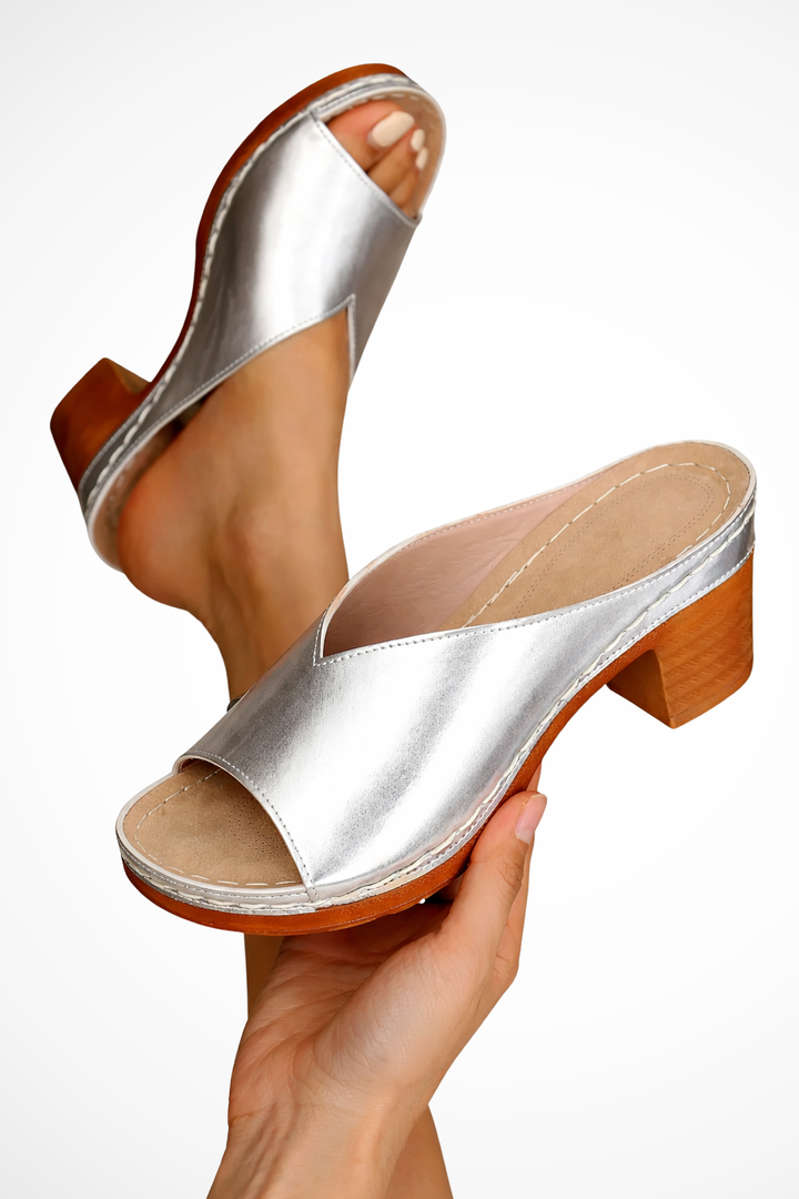 Close-up of comfortable block heel on women's open toe mules. Sturdy and chic, great for all-day party wear.