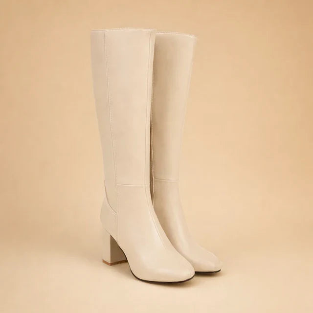 Stylish women's black over-the-knee high heel boots. Sleek design for elegant winter footwear.