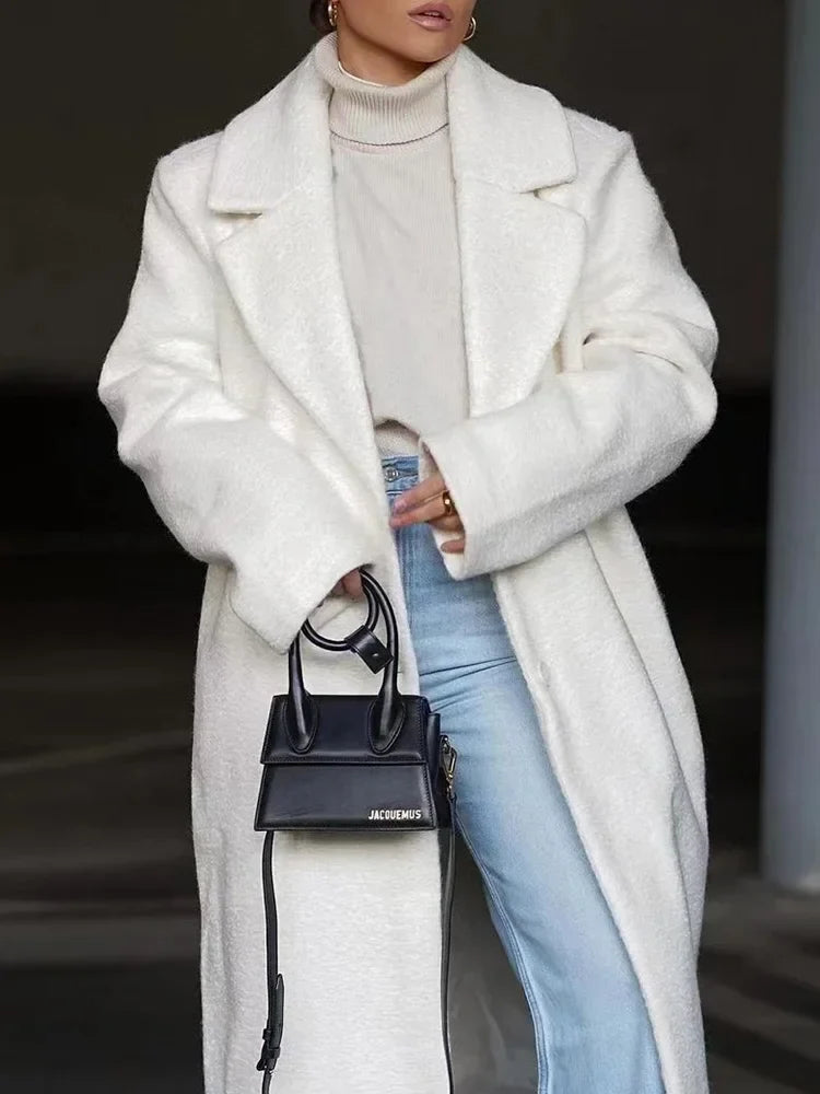 Effortless style women's elegant oversized coat. Features a chic lapel and button closure for winter.