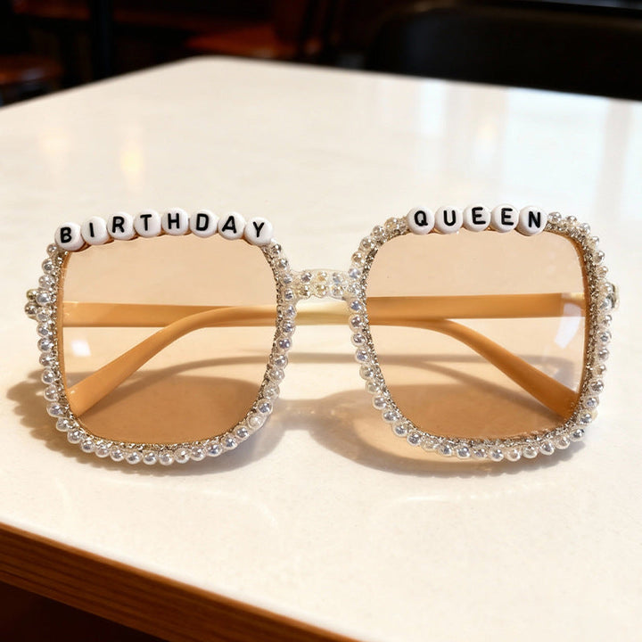 Statement pearl-embellished square sunglasses; perfect party accessory for a chic, glamorous women's look.