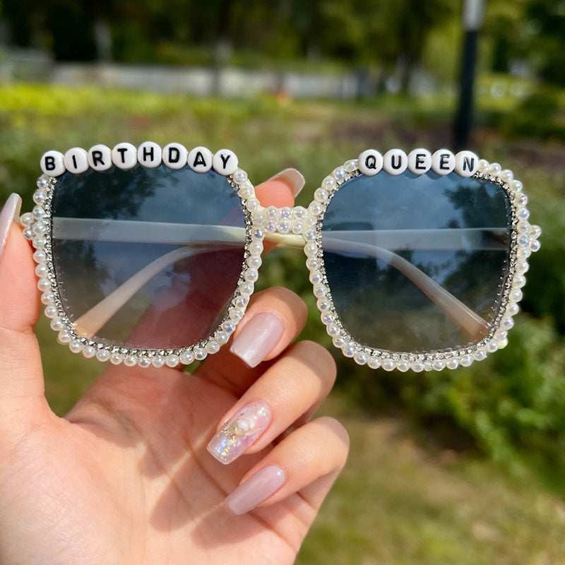 Close-up: Elegant women's square frame sunglasses, showcasing intricate pearl embellishments for a chic look.