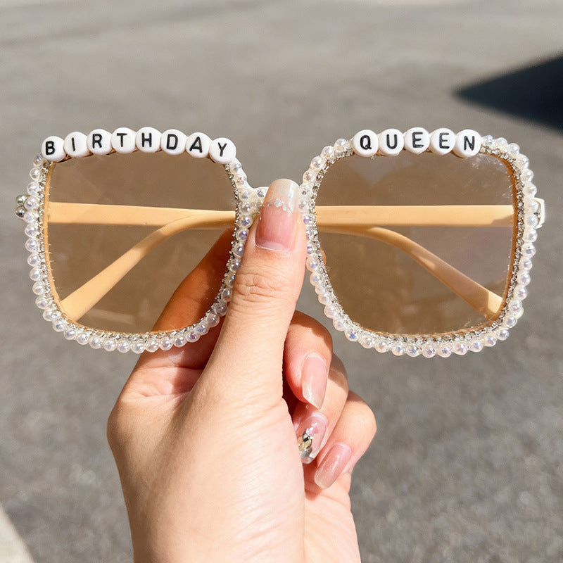 Pearl-detailed women's square statement sunglasses, offering UV protection; glamorous and chic fashion accessory.
