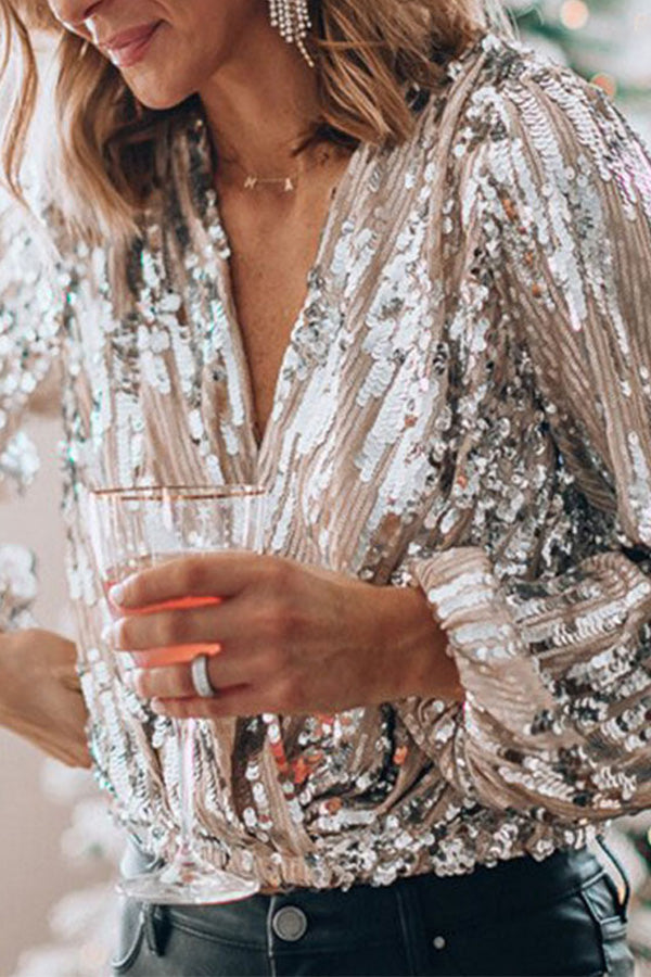 Versatile silver women's blouse, ideal for both casual fashion and elegant occasions. Shimmering ladies top.