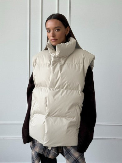 Trendy women's black puffer vest, a versatile sleeveless outerwear for fall fashion & casual warmth.