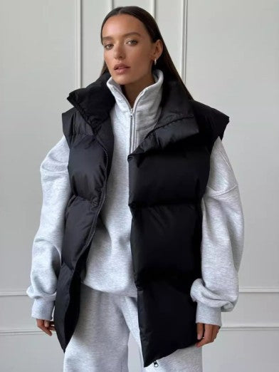 Warm women's apricot puffer vest, a chic sleeveless outerwear essential for cozy fall & winter styling.