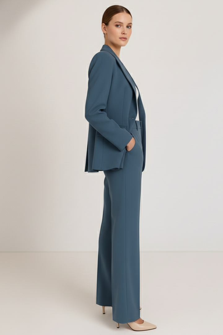 Back view of women's professional two-piece suit with tailored blazer & straight leg trousers for office.