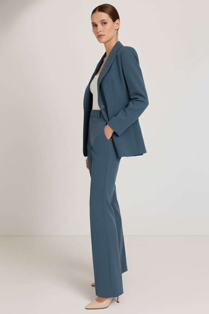 Side profile of a women's chic tailored blazer & straight leg trousers suit, ideal professional office attire.
