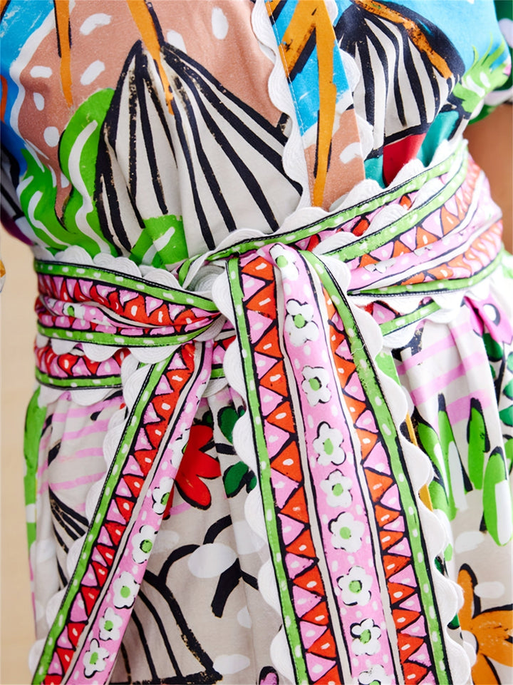Detail of the adjustable waist on a women's versatile tropical print midi dress for a flattering fit.
