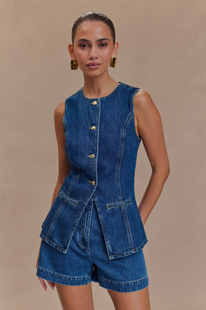 Chic women's two-piece outfit with sleeveless top & high-waist denim shorts. Perfect for summer fashion.