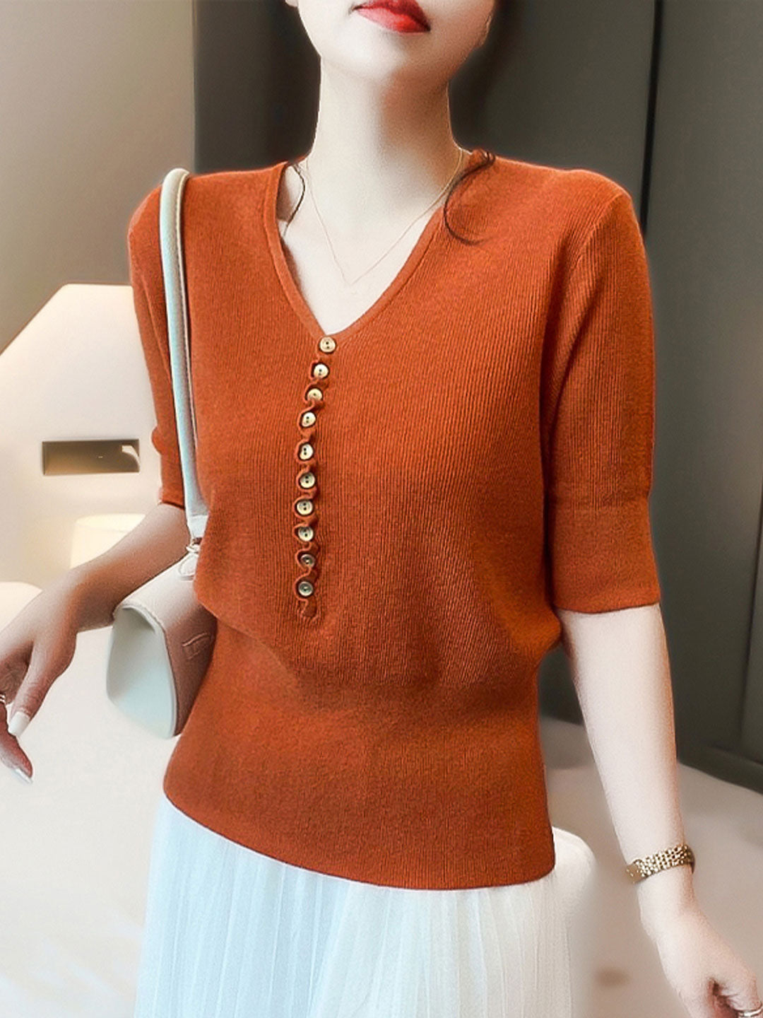 Fashionable women's V-neck button top, designed for comfortable everyday wear with a stylish long sleeve.