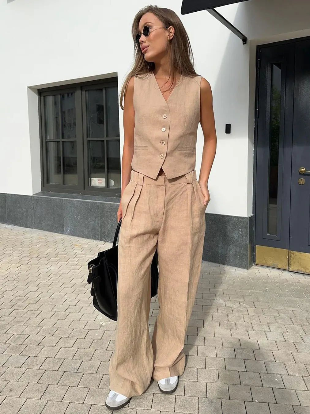 Complete women's outfit: a fashionable waistcoat and comfortable wide-leg pants for easy elegance.