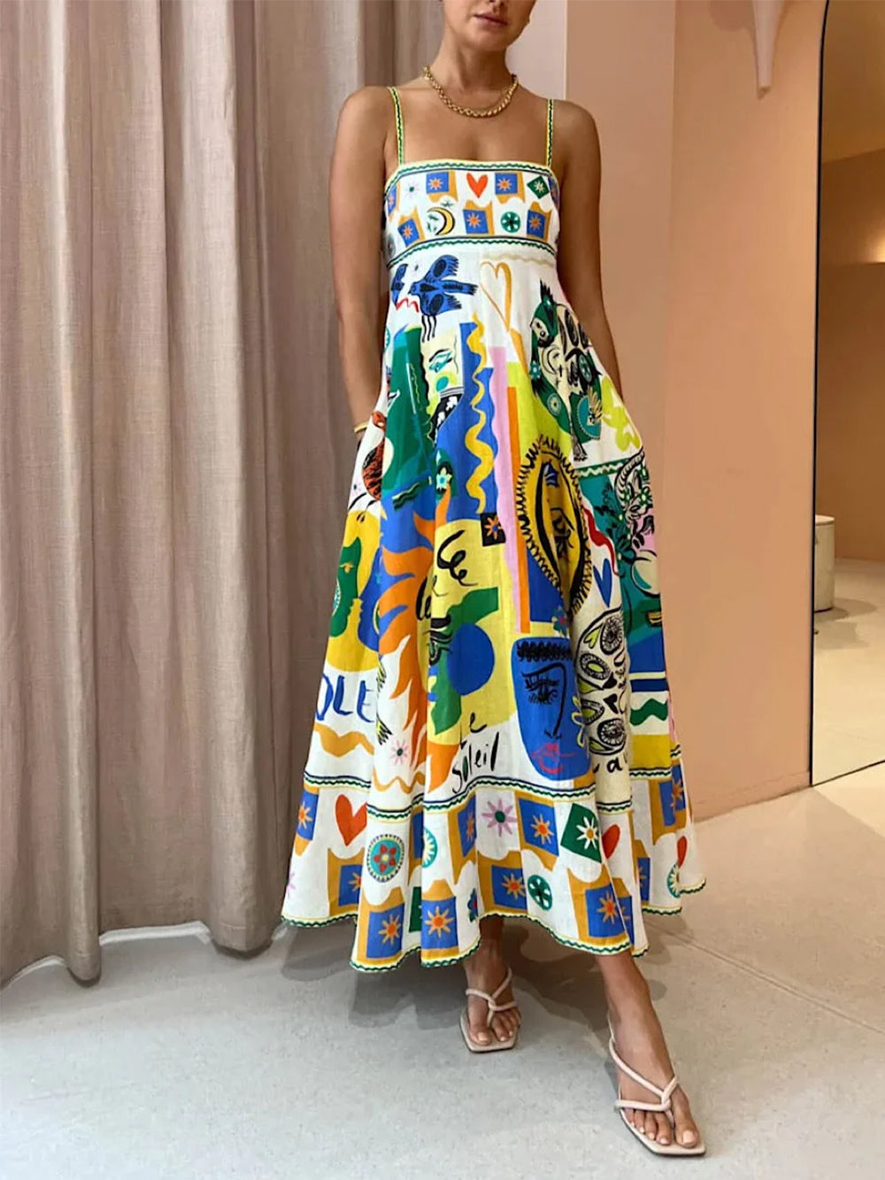Women's maxi slip dress with vibrant geometric graffiti print, a chic and artistic summer dress in yellow.
