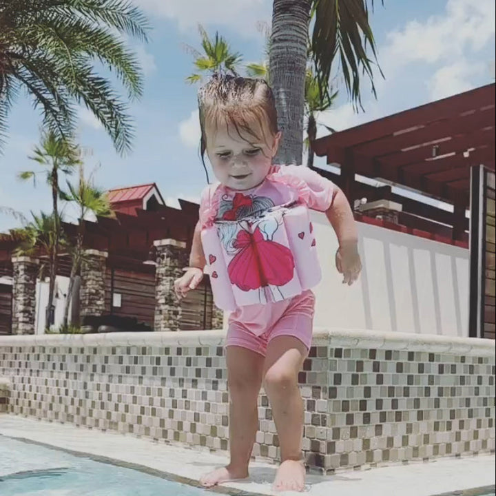 Children's bright pink life jacket, perfect for girls' safe water adventures.