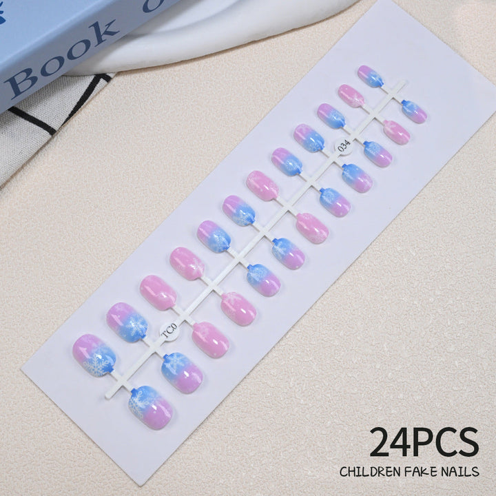 Festive girls' press-on nail set, 24 holiday themes, non-toxic & cute for young kids.