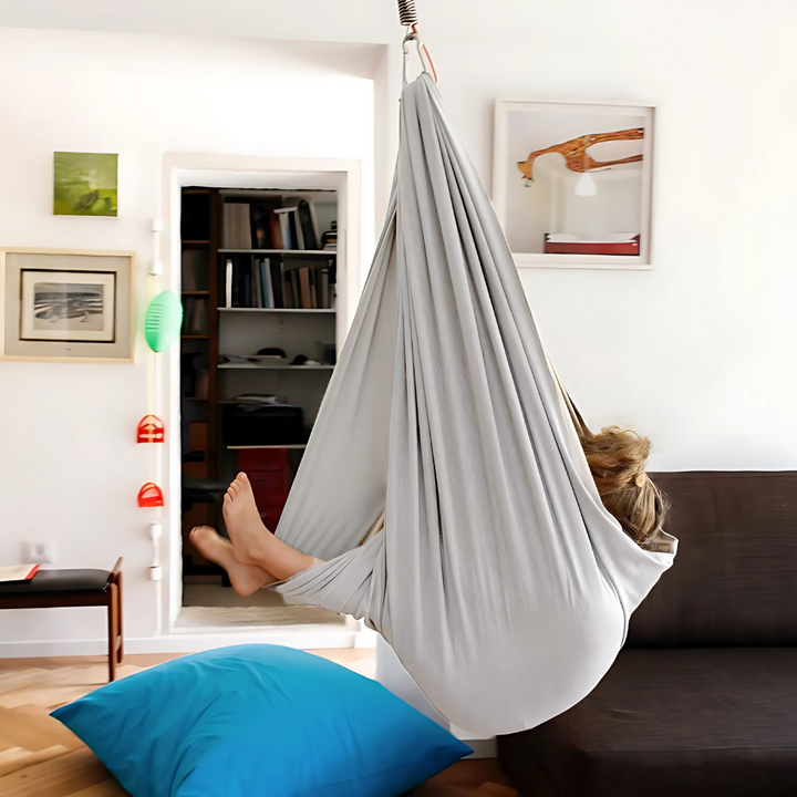 Calming children's sensory hammock swing provides gentle compression & comfort for kids with ADHD, autism.