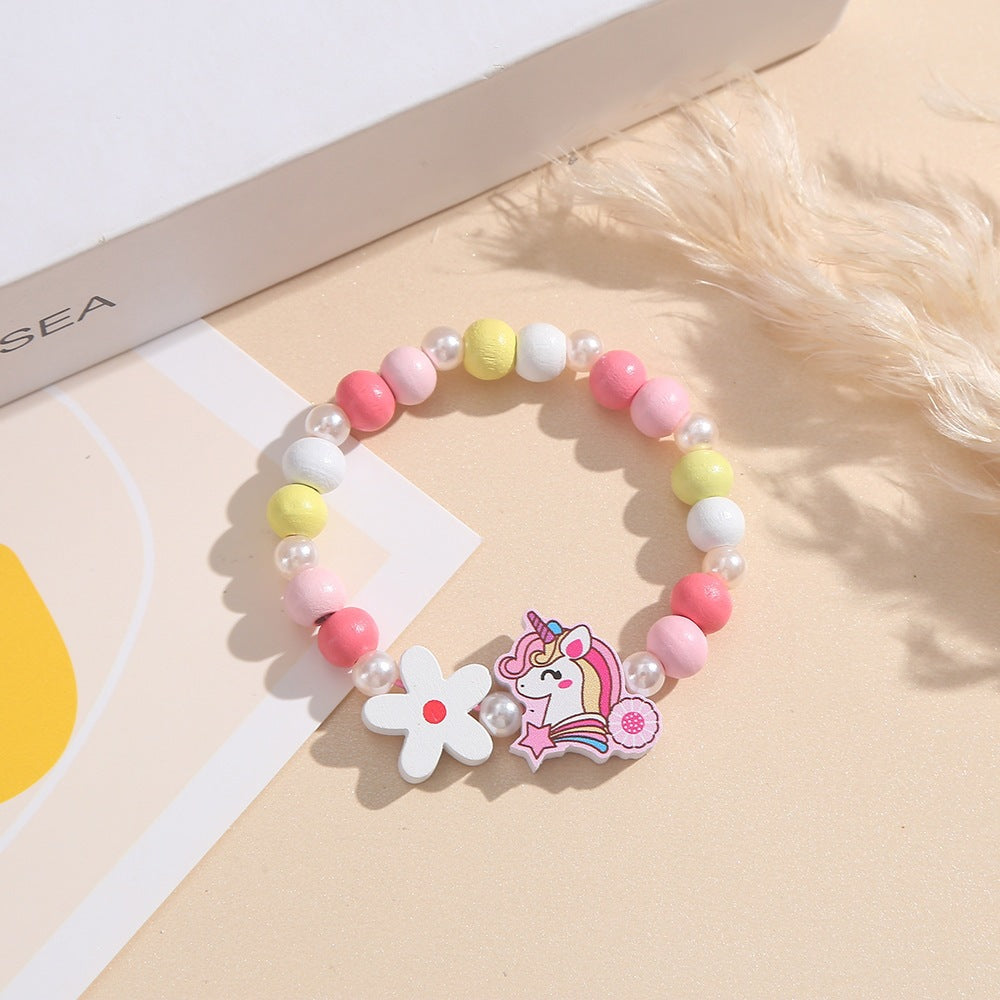Cute children's bracelet: unicorn, flower, and colorful wood beads, perfect playful accessory.
