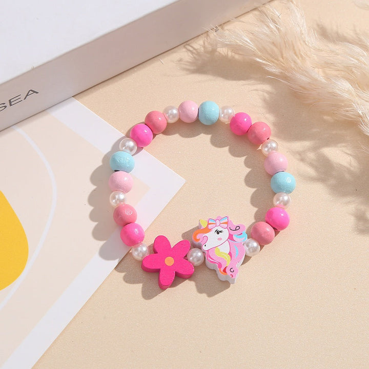 Girls' playful bracelet: unicorn, flower, and colorful wood beads, a charming accessory.