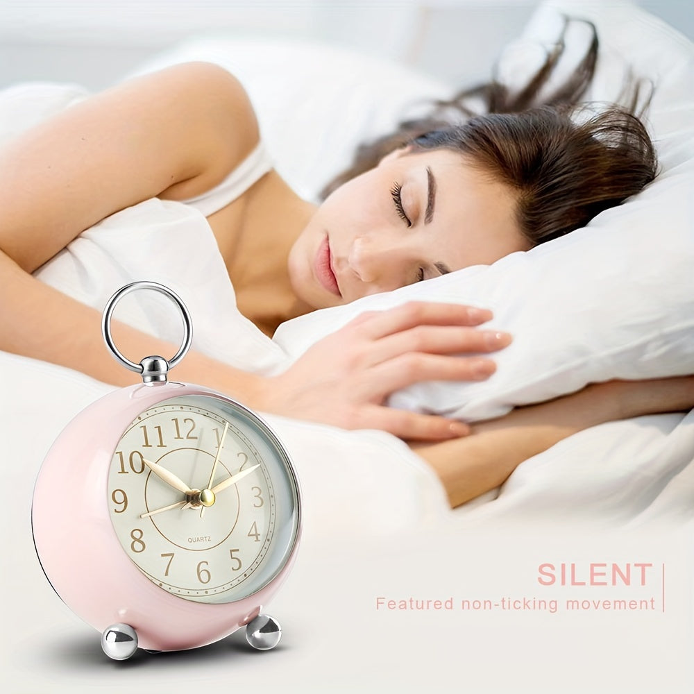 Vintage round analogue alarm clock on a table, showcasing its night light and silent function for decor.