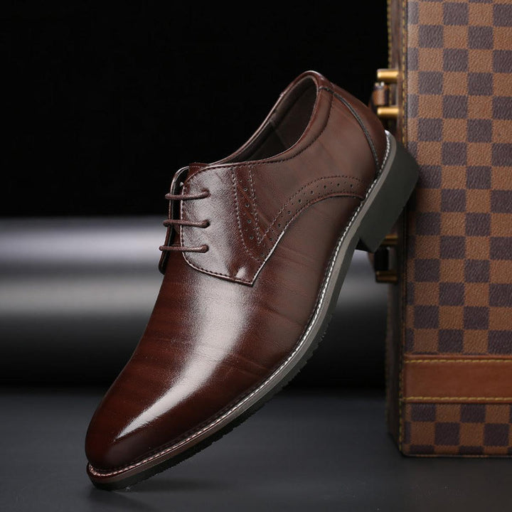 Classic black leather men's lace-up formal shoes, perfect for business or wedding attire.