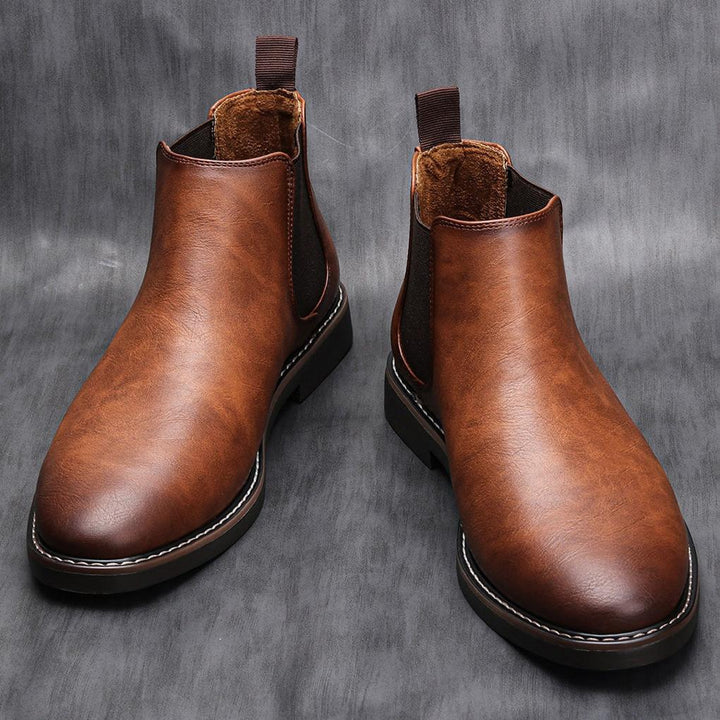 Classic brown leather men's Chelsea boots, sleek ankle style, versatile for dress or casual wear.