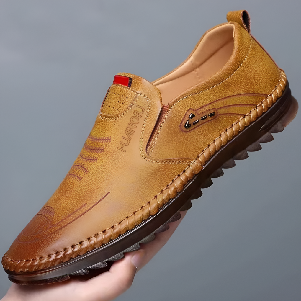 Classic men's brown leather loafers, perfect for versatile casual or formal wear. Comfortable slip-on design.