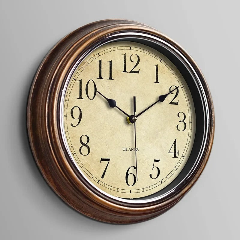 Classic round silent wall clock, elegant metal design for timeless home & office decor.
