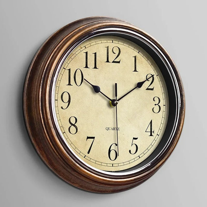 Classic round silent wall clock, elegant metal design for timeless home & office decor.