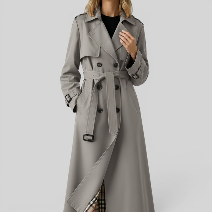 Sophisticated double-breasted women's trench coat. Elegant longline outerwear for a chic look.