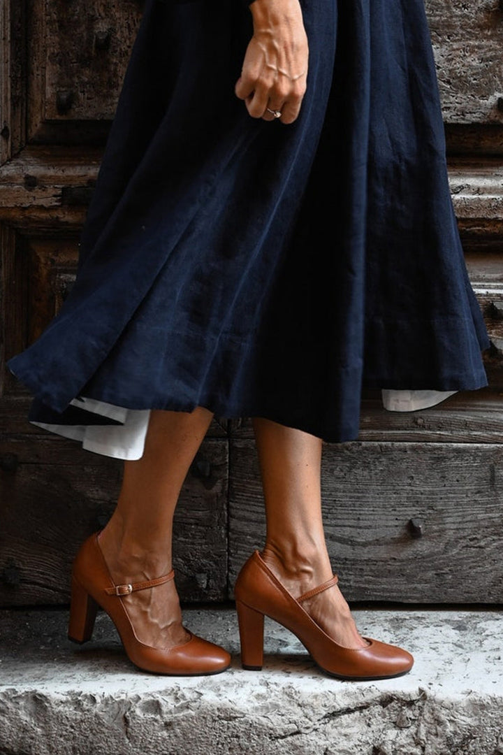 Stylish women's brown Mary Jane shoes, featuring a sturdy block heel, rounded toe, and secure strap for comfort.