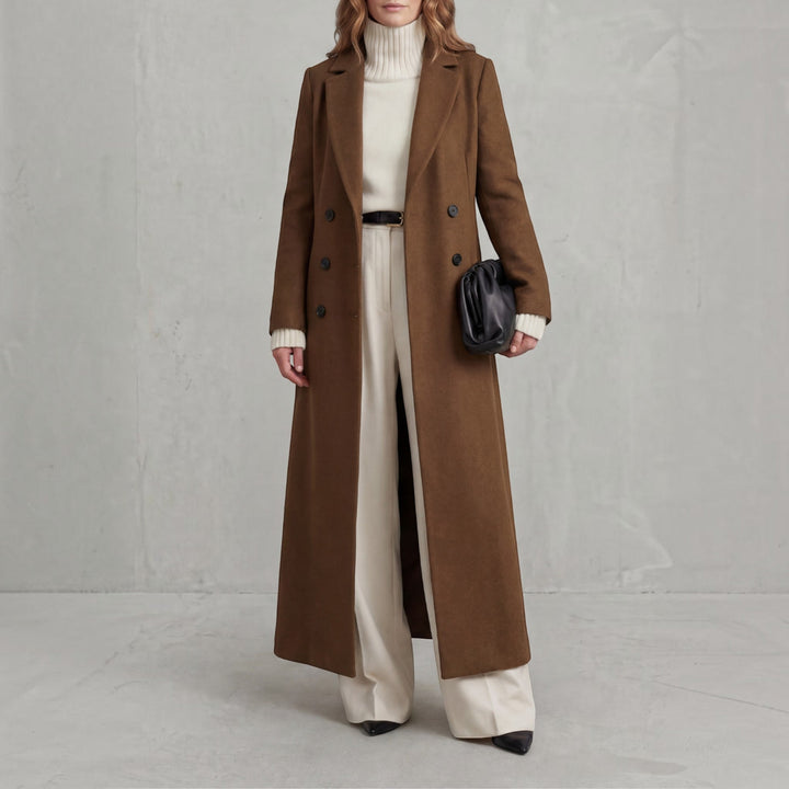 Long double-breasted trench coat for women, sophisticated fall fashion outerwear.