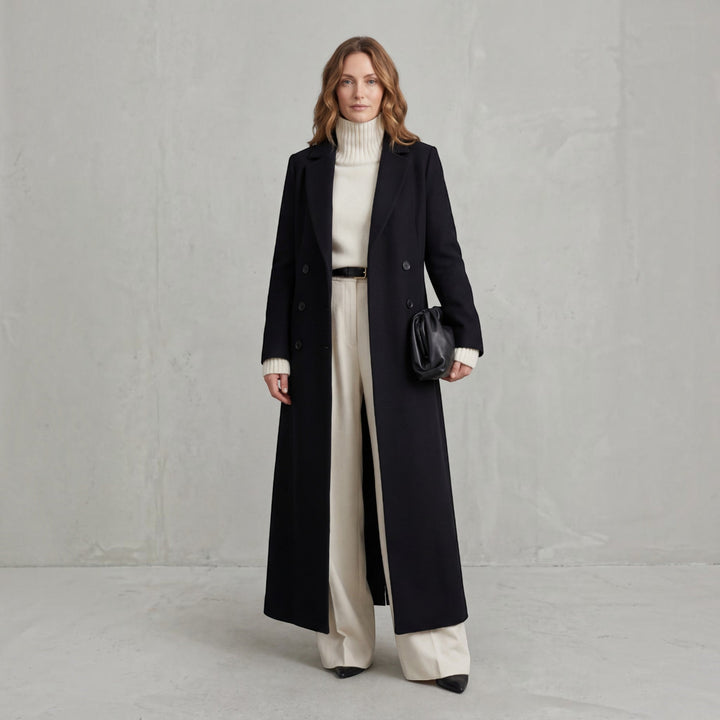 Classic women's double-breasted maxi trench coat, ideal elegant outerwear for fall.