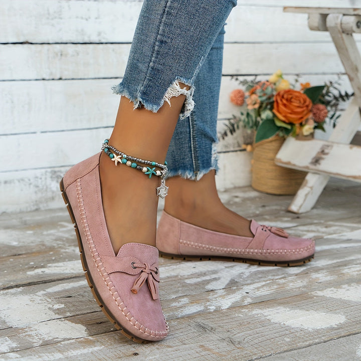 Side view: Women's classic tassel loafers, emphasizing comfort & elegant everyday style. Stylish slip-on footwear.