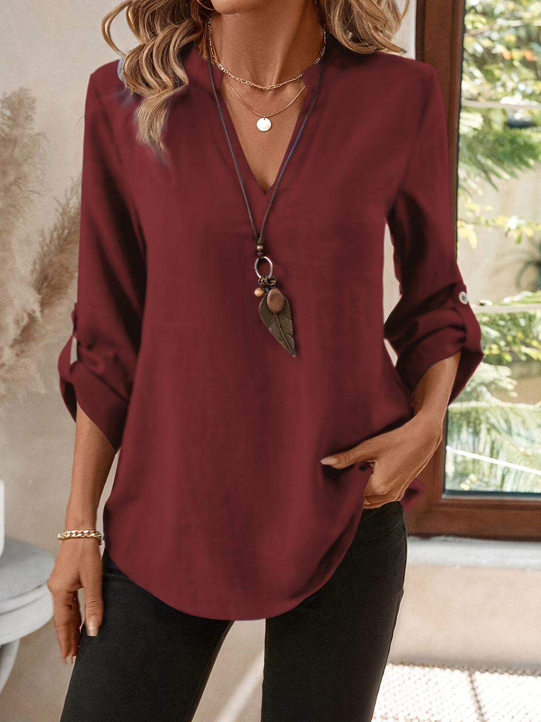 Versatile women's classic V-neck long sleeve shirt for casual or elegant layered fashion.