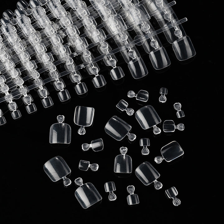 Full set of clear soft gel nail extension tips, essential beauty supplies for professional and home manicure needs.