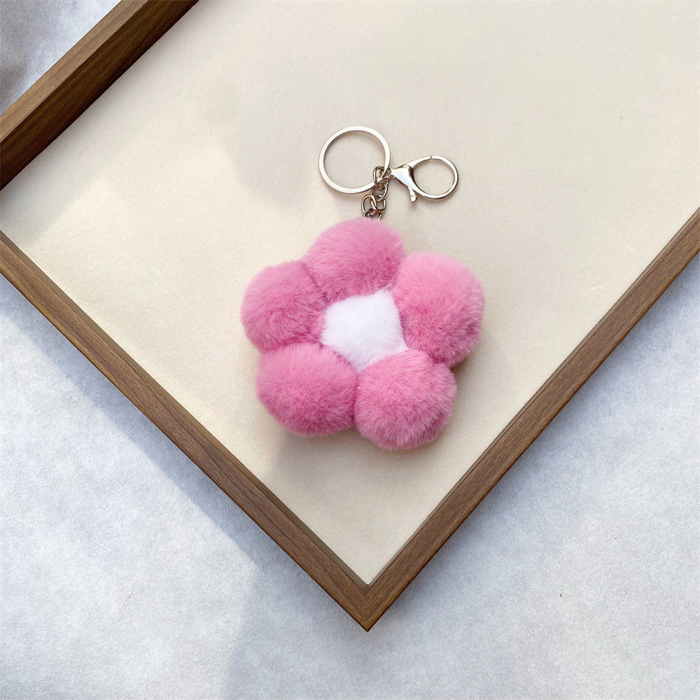 Detail view of a charming floral plush key accessory, soft fabric and vibrant design.