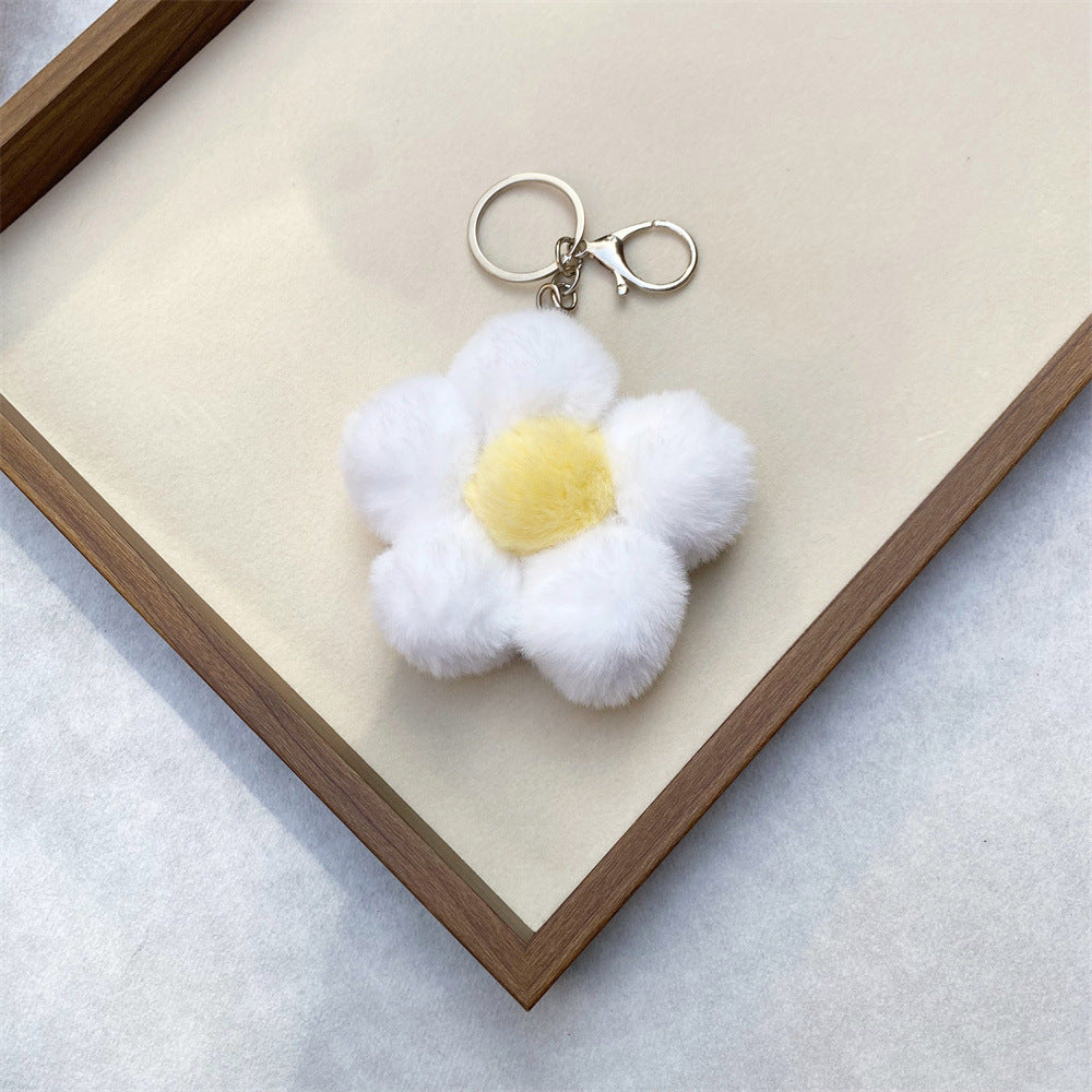 Whimsical plush flower keychain for keys or bags, a cute and soft accessory.