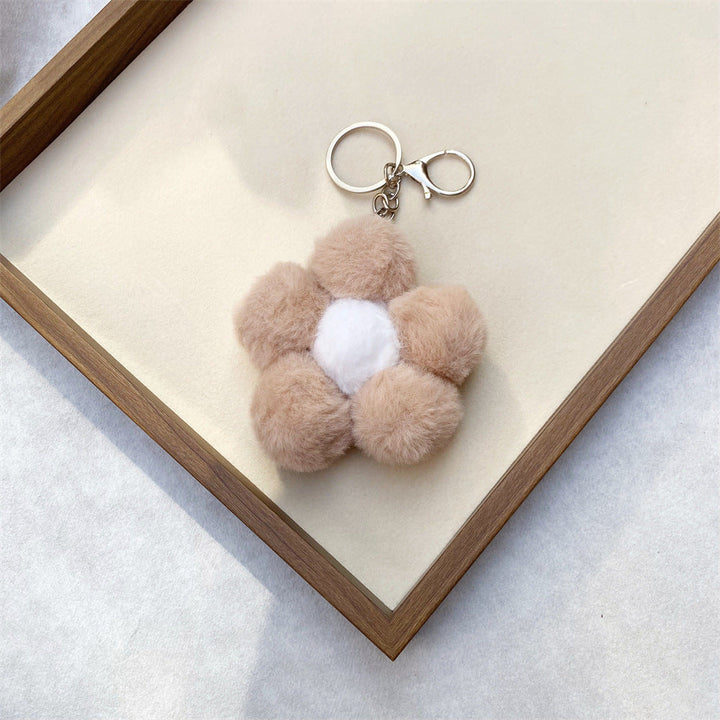 Hand holding a soft, squishy floral plush keychain, a cute and functional accessory.