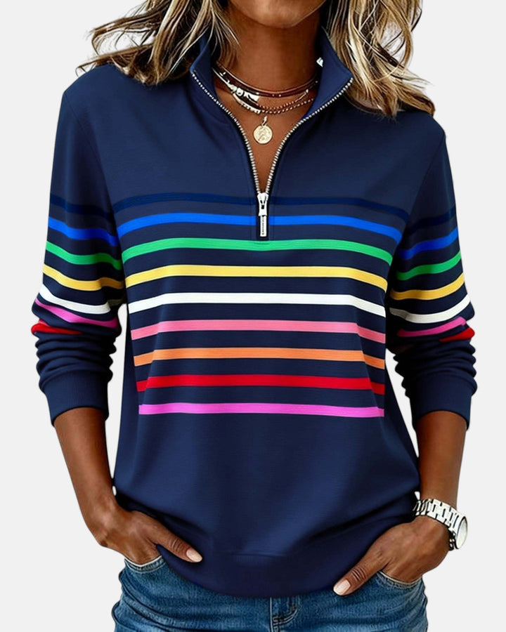 Woman smiling in a relaxed fit striped long sleeve pullover, perfect for casual everyday wear.