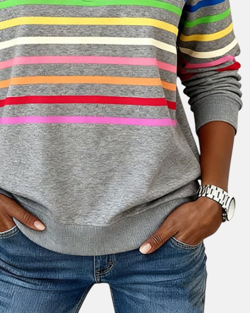 Woman walking casually in a comfy striped long sleeve pullover, great for daily outfits.