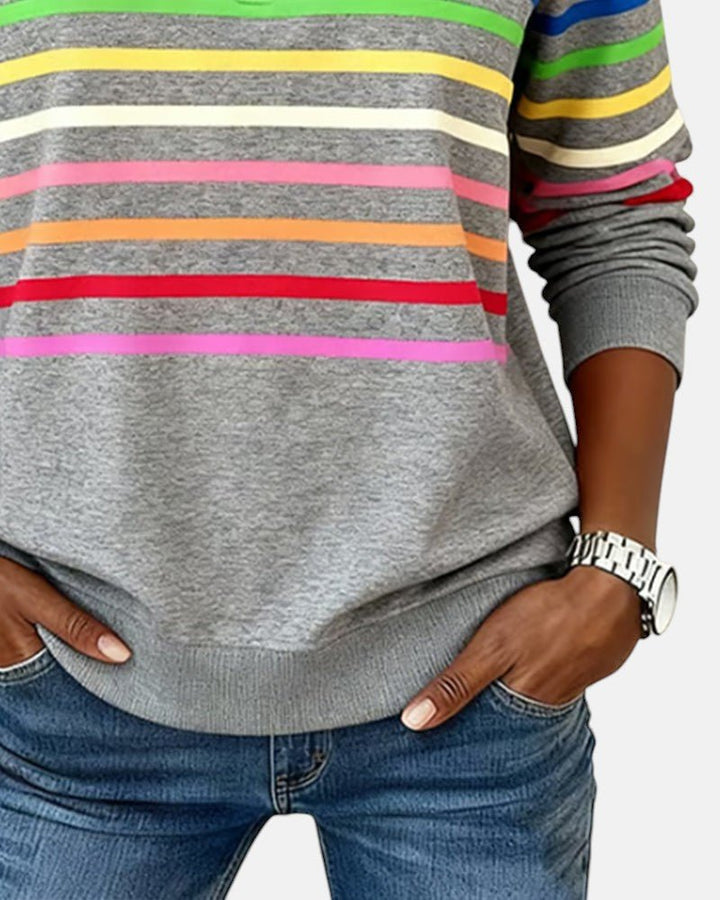 Woman walking casually in a comfy striped long sleeve pullover, great for daily outfits.