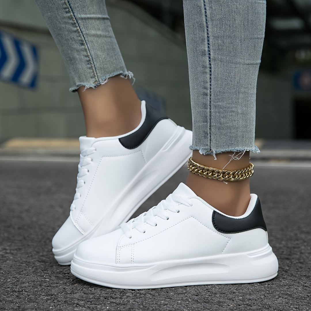 Full view of lightweight white women's sneakers, ideal for versatile everyday wear & comfort.