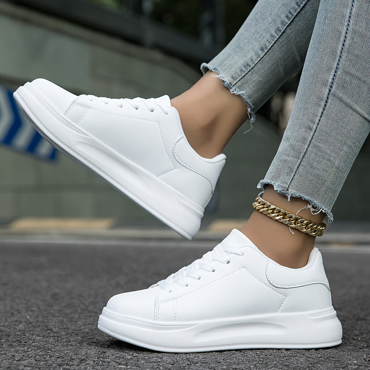 Minimalist white women's sneakers, perfect comfortable footwear for versatile everyday activities.